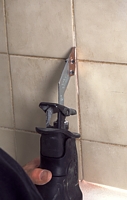 Grout Grabber in use. effective grout removal, grout grabber, remove tile grout, reciprocating saw, replaceable blades, carbide grit coated blades, remove damaged grout, removed mildewed grout, correct grout grabber blade thickness